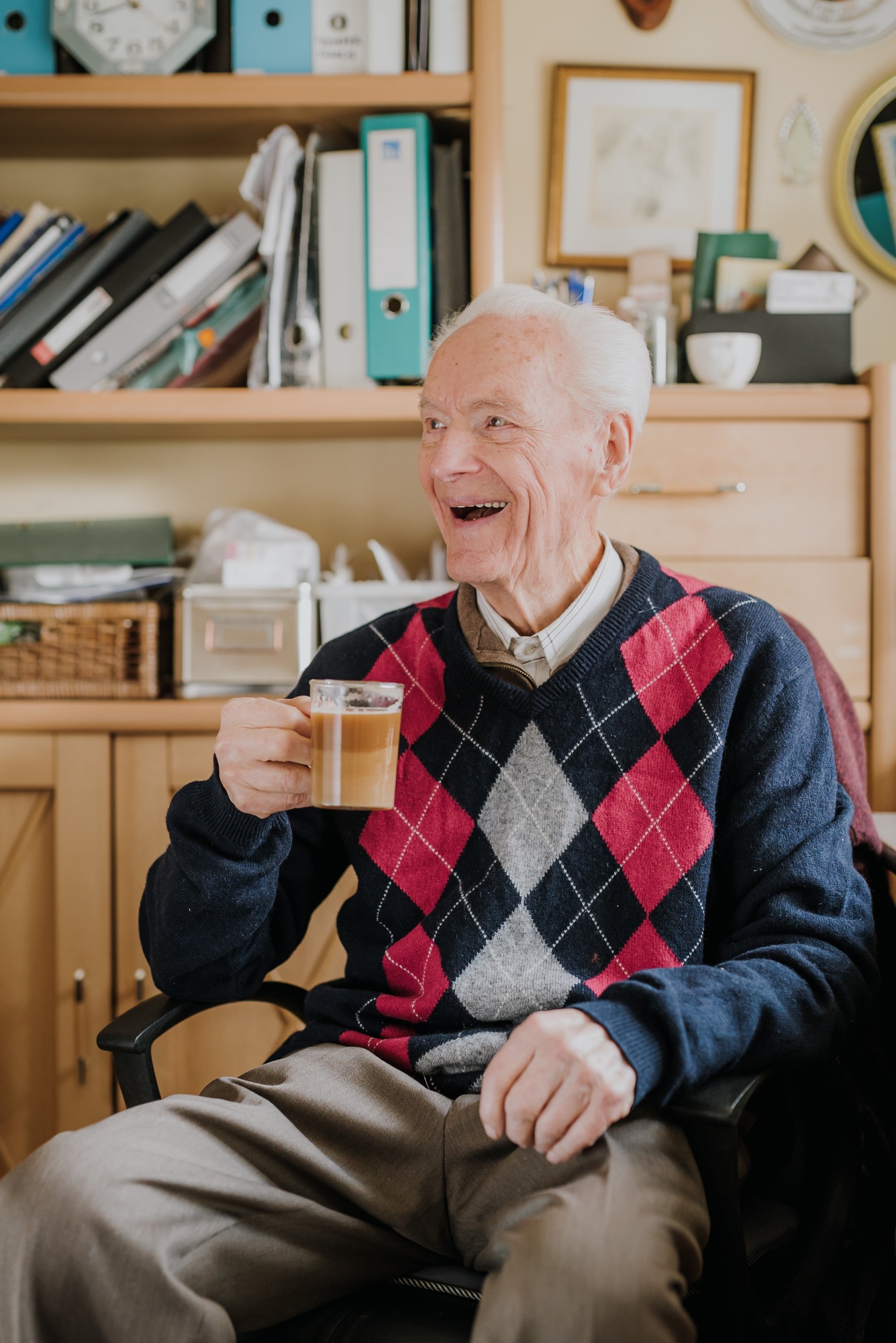 Old man drinking coffee at home